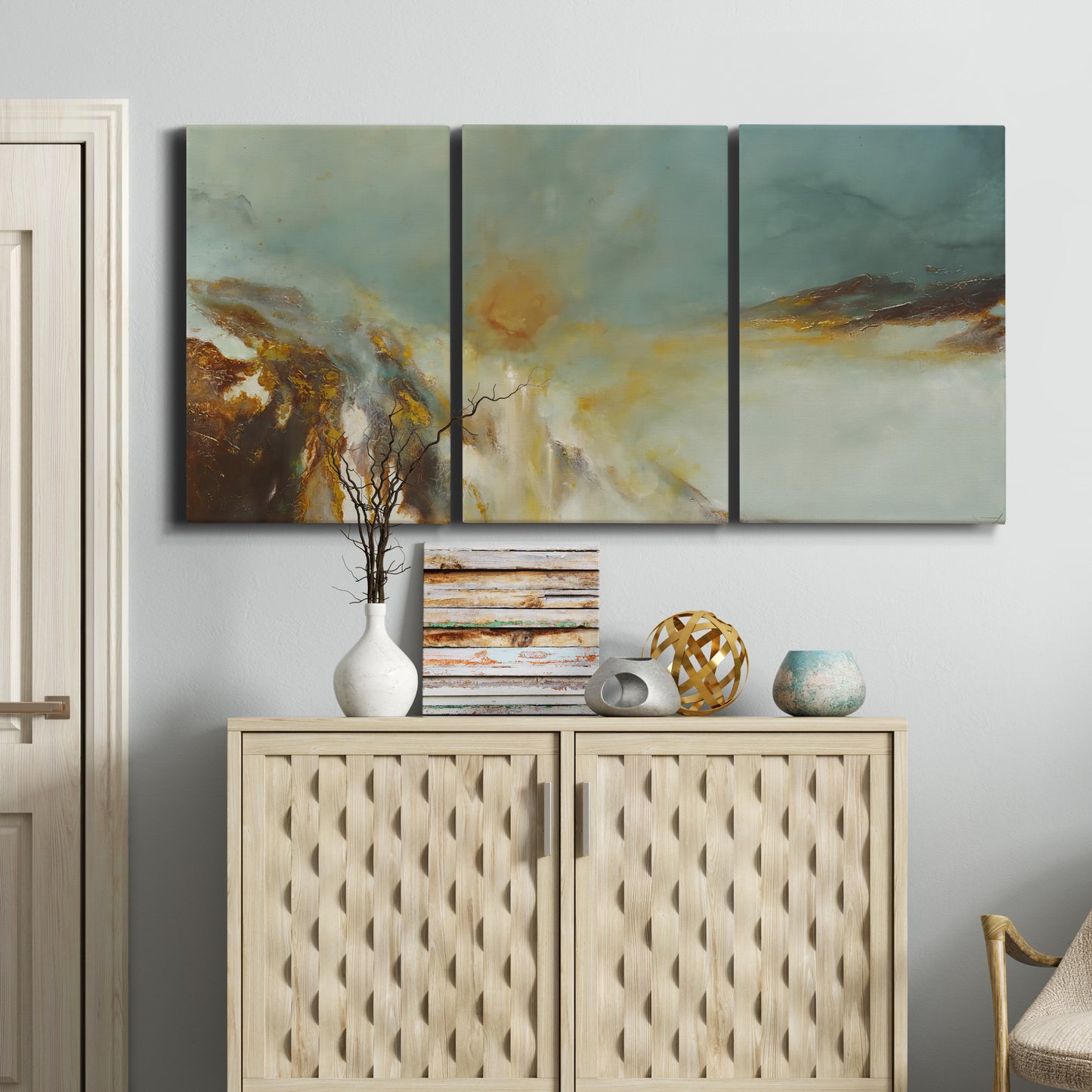 Three-panel canvas wall art featuring earth toned abstract solar landscape, displayed above a cabinet in an entryway.