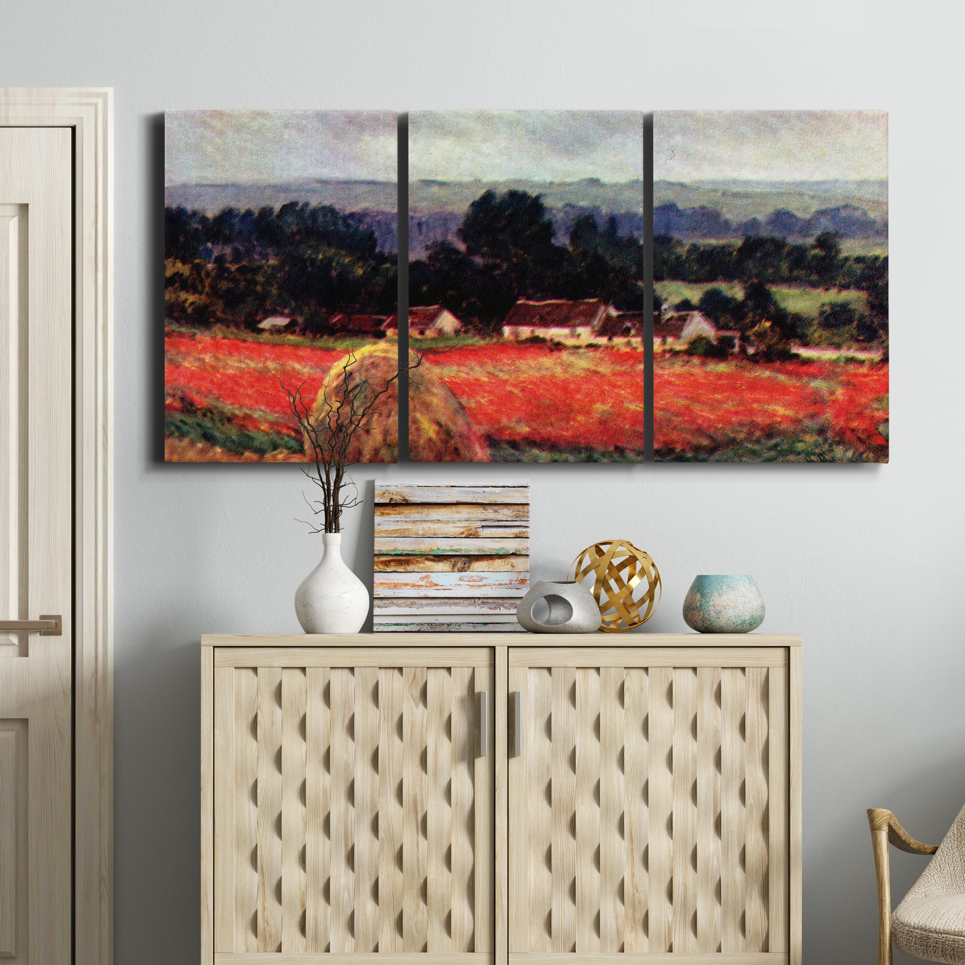 Three-panel canvas wall art featuring red poppy field near barn, displayed above a cabinet in an entryway.