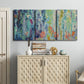 Three-panel canvas wall art featuring abstract rainfall with butterfly forms, displayed above a cabinet in an entryway.