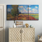 Three-panel canvas wall art featuring summer poppy field in bloom, displayed above a cabinet in an entryway.