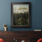 Dreamlike forest landscape scene by Henri Rousseau in an ornate black frame with gilded inner detail displayed in a dark-toned interior setting.