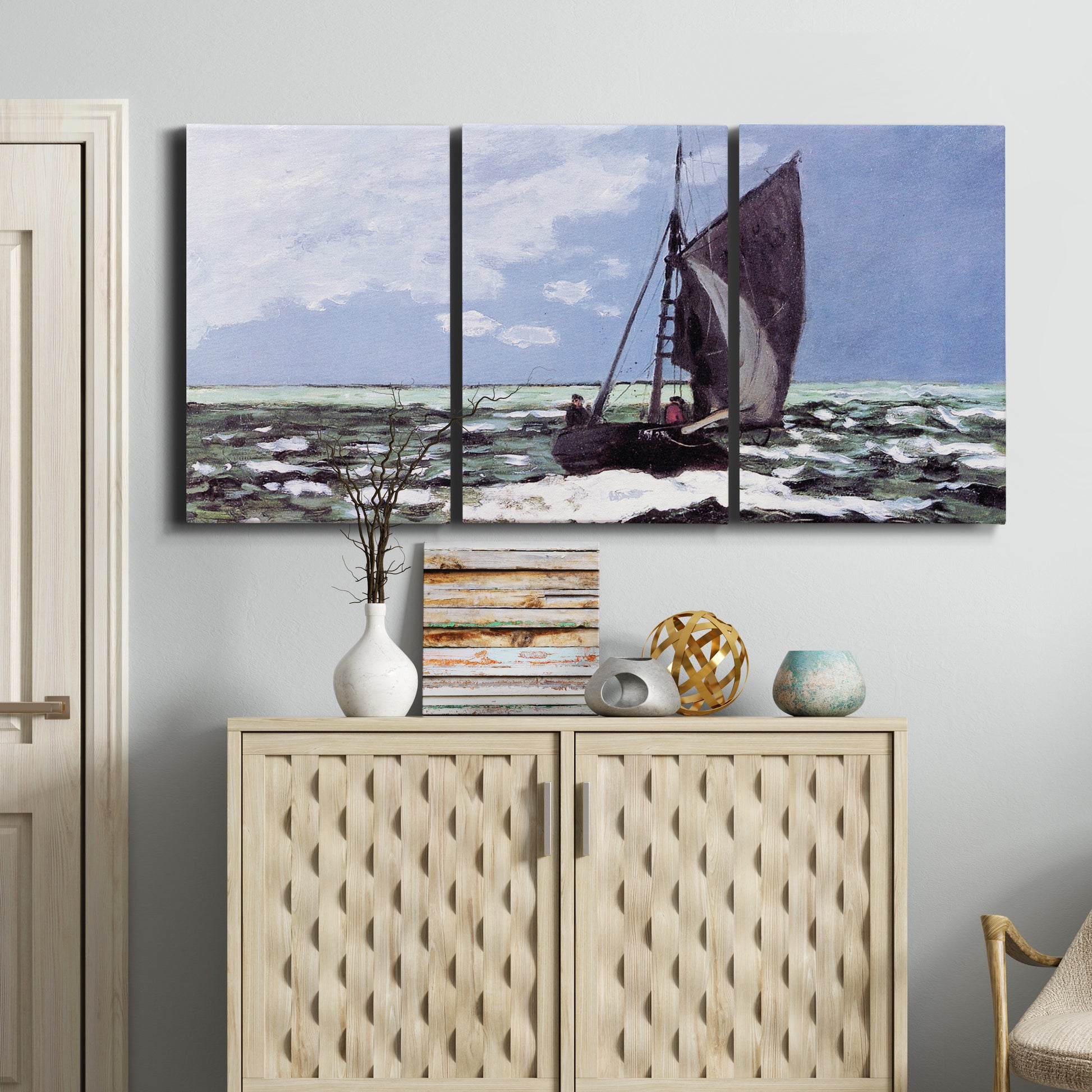 Three-panel canvas wall art featuring stormy sea with crashing waves, displayed above a cabinet in an entryway.