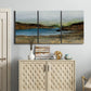 Three-panel canvas wall art featuring peaceful lakeside shoreline landscape, displayed above a cabinet in an entryway.
