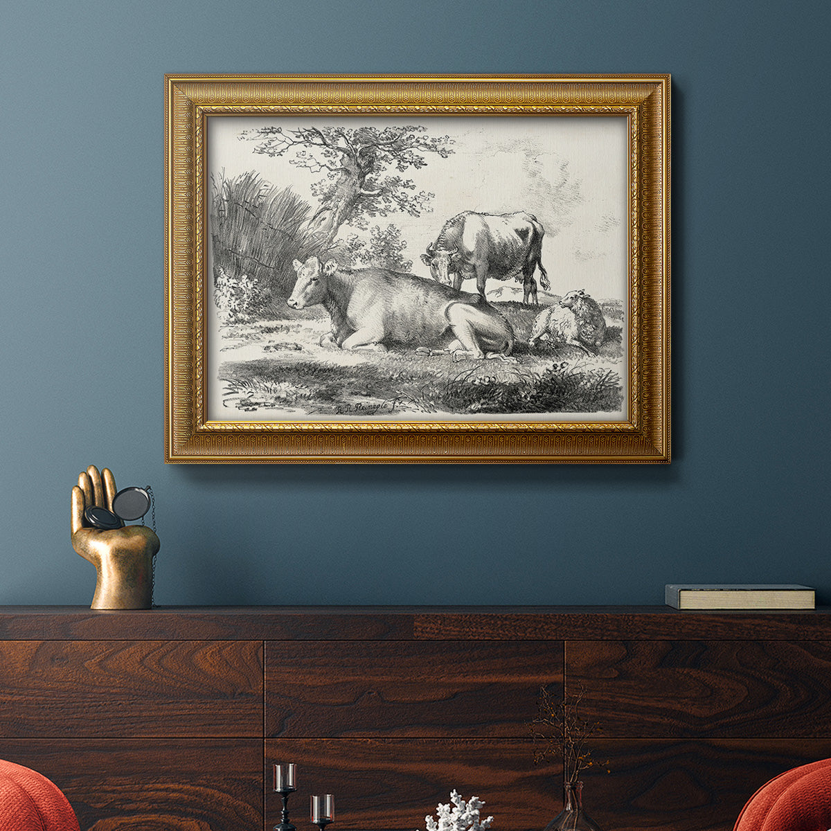 Classical pastoral landscape artwork by Nicolas Berchem in an ornate traditional gold frame displayed in a dark-toned interior setting.