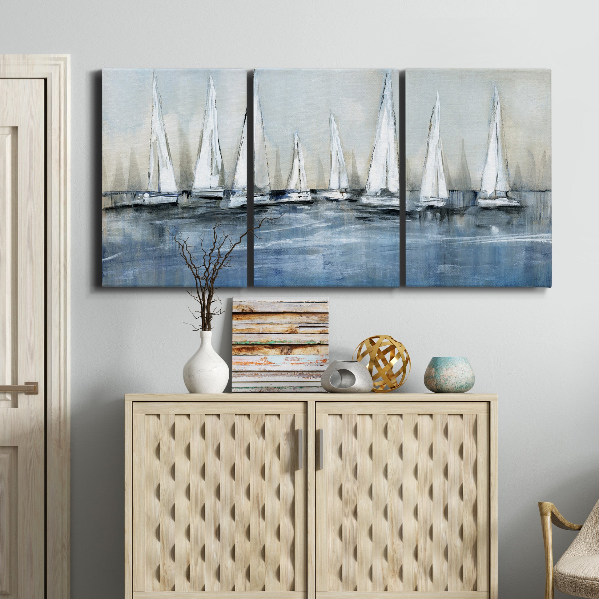 Three-panel canvas wall art featuring still life with pears and grapes, displayed above a cabinet in an entryway.