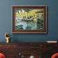 Impressionist riverside leisure scene by Claude Monet in an ornate bronzed mahogany wood frame displayed in a dark-toned interior setting.
