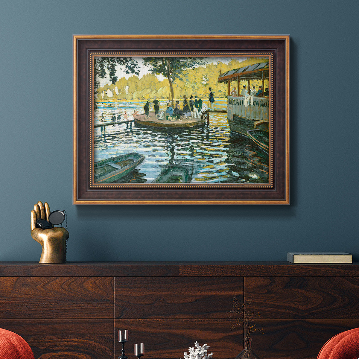 Impressionist riverside leisure scene by Claude Monet in an ornate bronzed mahogany wood frame displayed in a dark-toned interior setting.