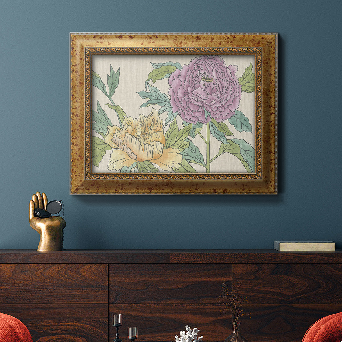 Contemporary peony flower illustration in an ornate vintage gold frame displayed in a dark-toned interior setting.