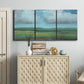 Three-panel canvas wall art featuring wide valley landscape with rolling hills, displayed above a cabinet in an entryway.