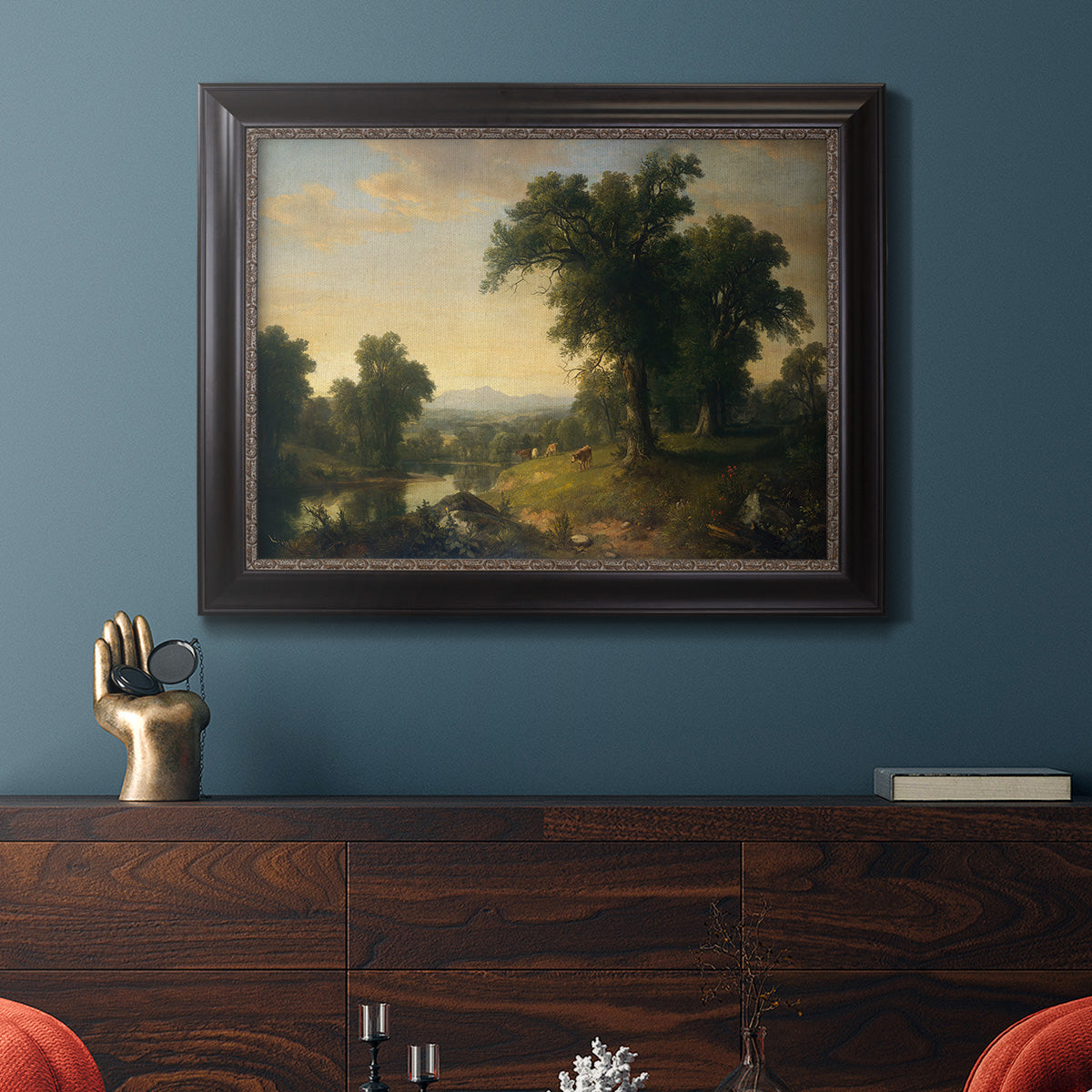 Traditional pastoral landscape painting by Asher Brown Durand in an ornate black frame with gilded inner detail displayed in a dark-toned interior setting.