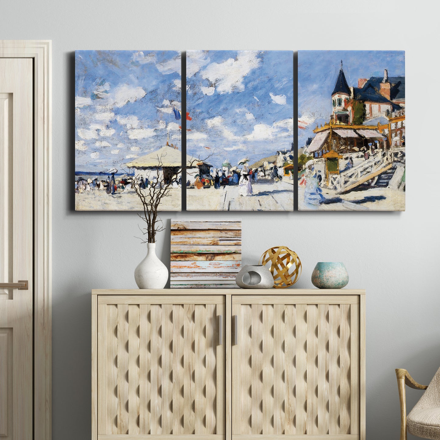 Three-panel canvas wall art featuring beach boardwalk with figures, displayed above a cabinet in an entryway.