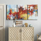 Three-panel canvas wall art featuring abstract city lights composition, displayed above a cabinet in an entryway.