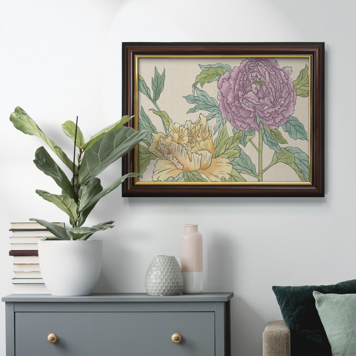 Contemporary peony flower illustration in an ornate mahogany wood frame with gold liner displayed in a dark-toned interior setting.