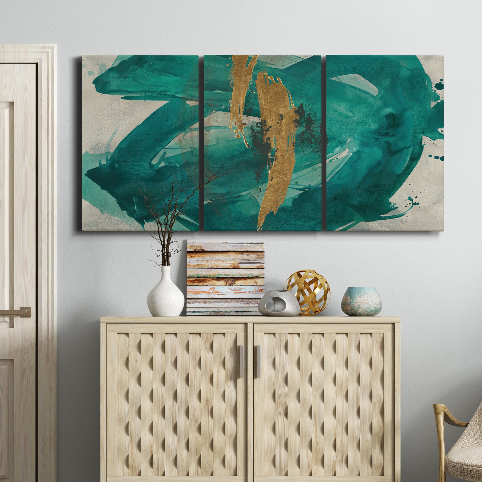Three-panel canvas wall art featuring interconnected abstract flowing forms, displayed above a cabinet in an entryway.