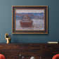 Impressionist single haystack landscape by Claude Monet in an ornate bronzed mahogany wood frame displayed in a dark-toned interior setting.