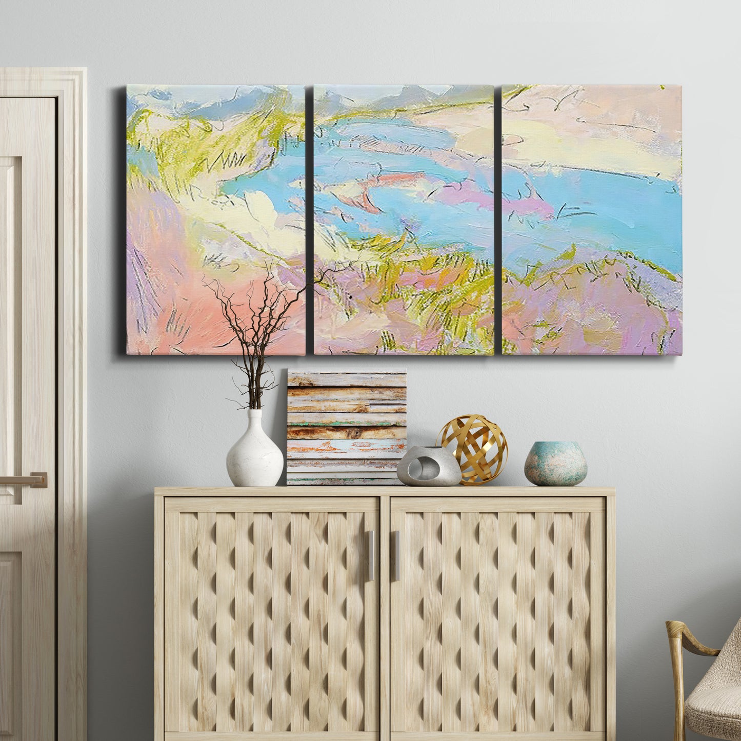 Three-panel canvas wall art featuring geometric mid century abstract blocks, displayed above a cabinet in an entryway.