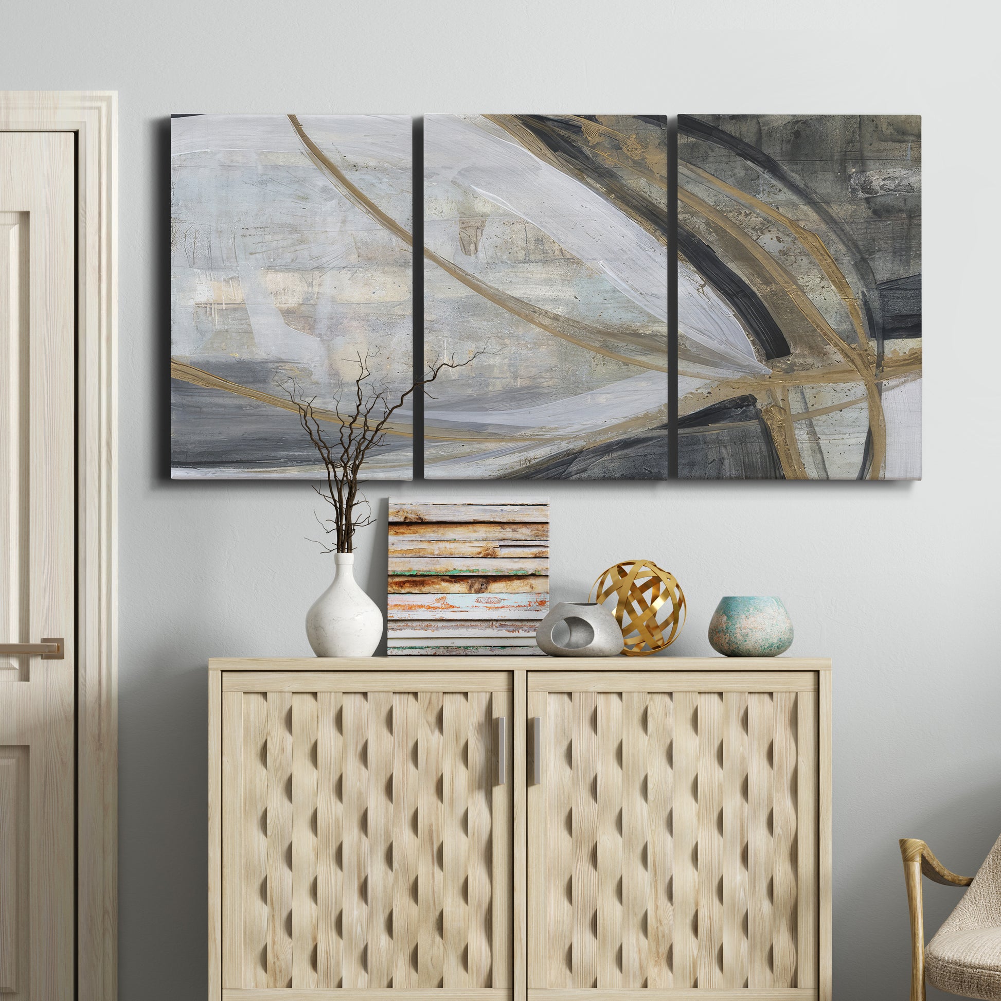 Three-panel canvas wall art featuring spiraling abstract vortex motion, displayed above a cabinet in an entryway.