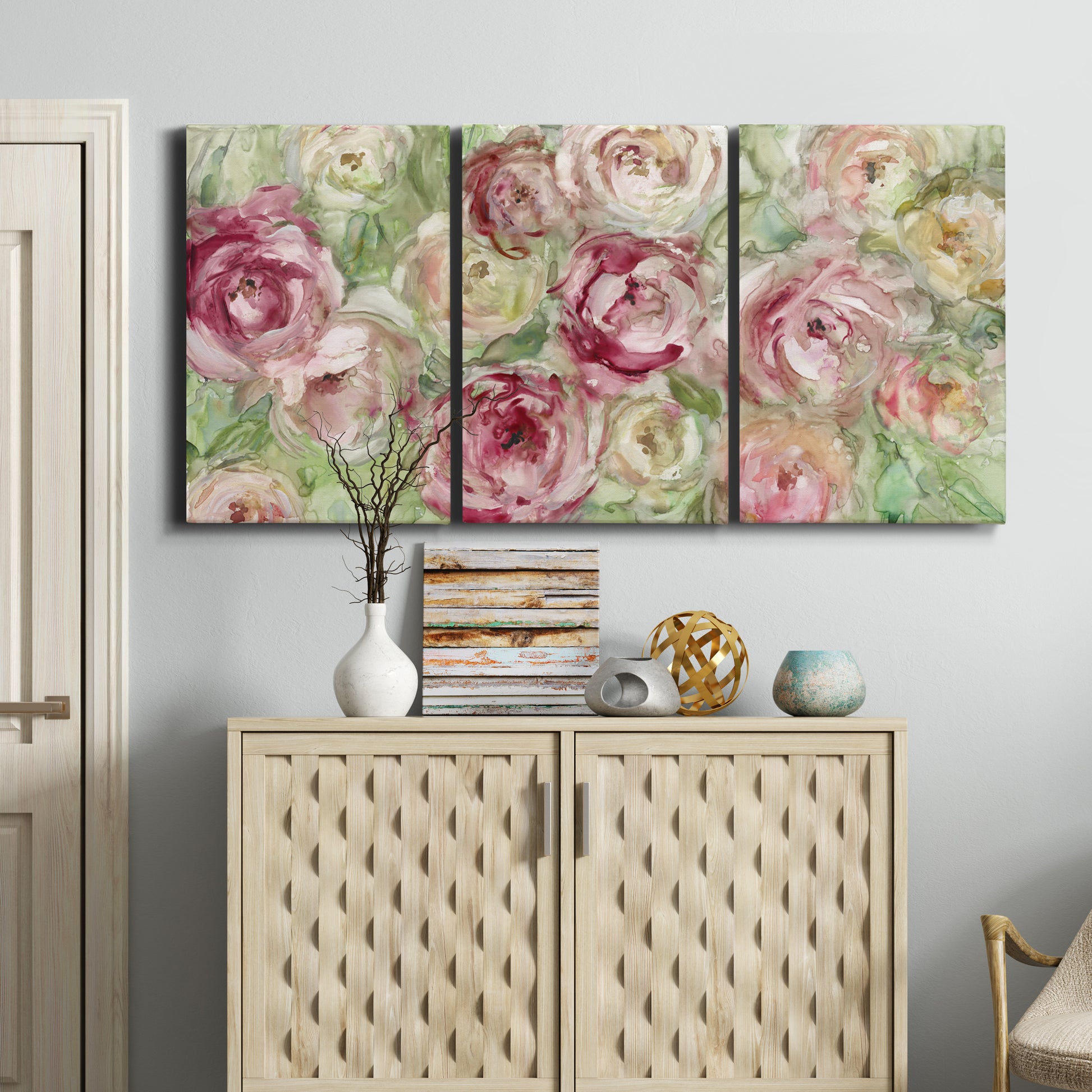 Three-panel canvas wall art featuring blooming climbing rose, displayed above a cabinet in an entryway.