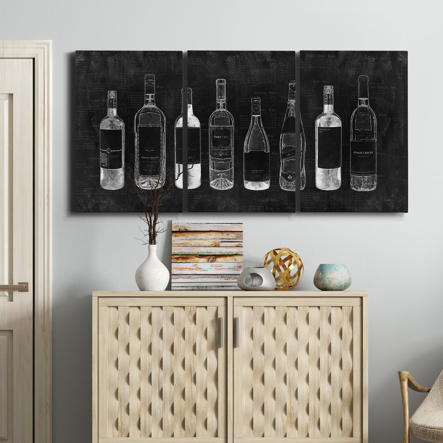 Three-panel canvas wall art featuring illustrated wine bottle cellar diagram, displayed above a cabinet in an entryway.