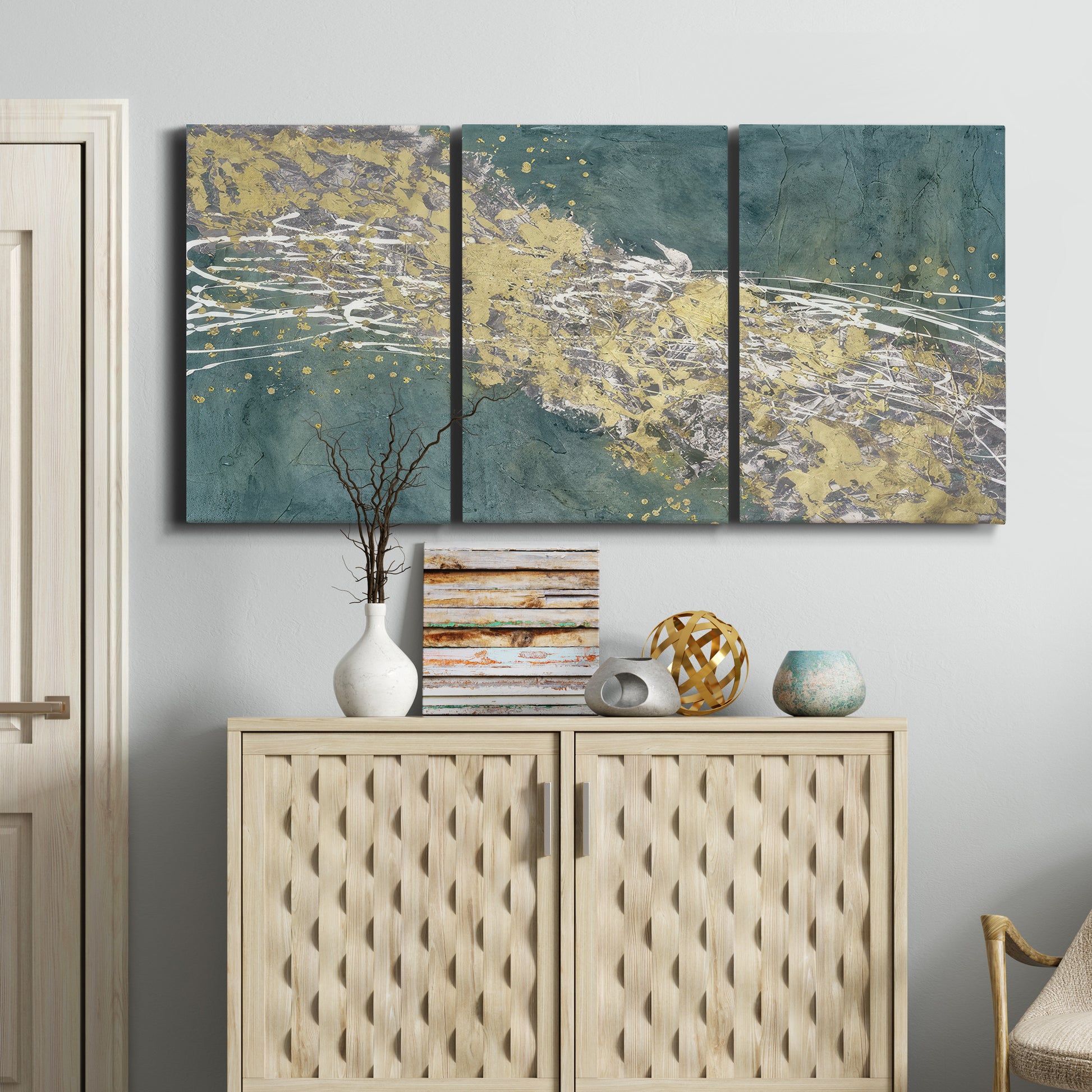 Three-panel canvas wall art featuring soft abstract wind movement, displayed above a cabinet in an entryway.