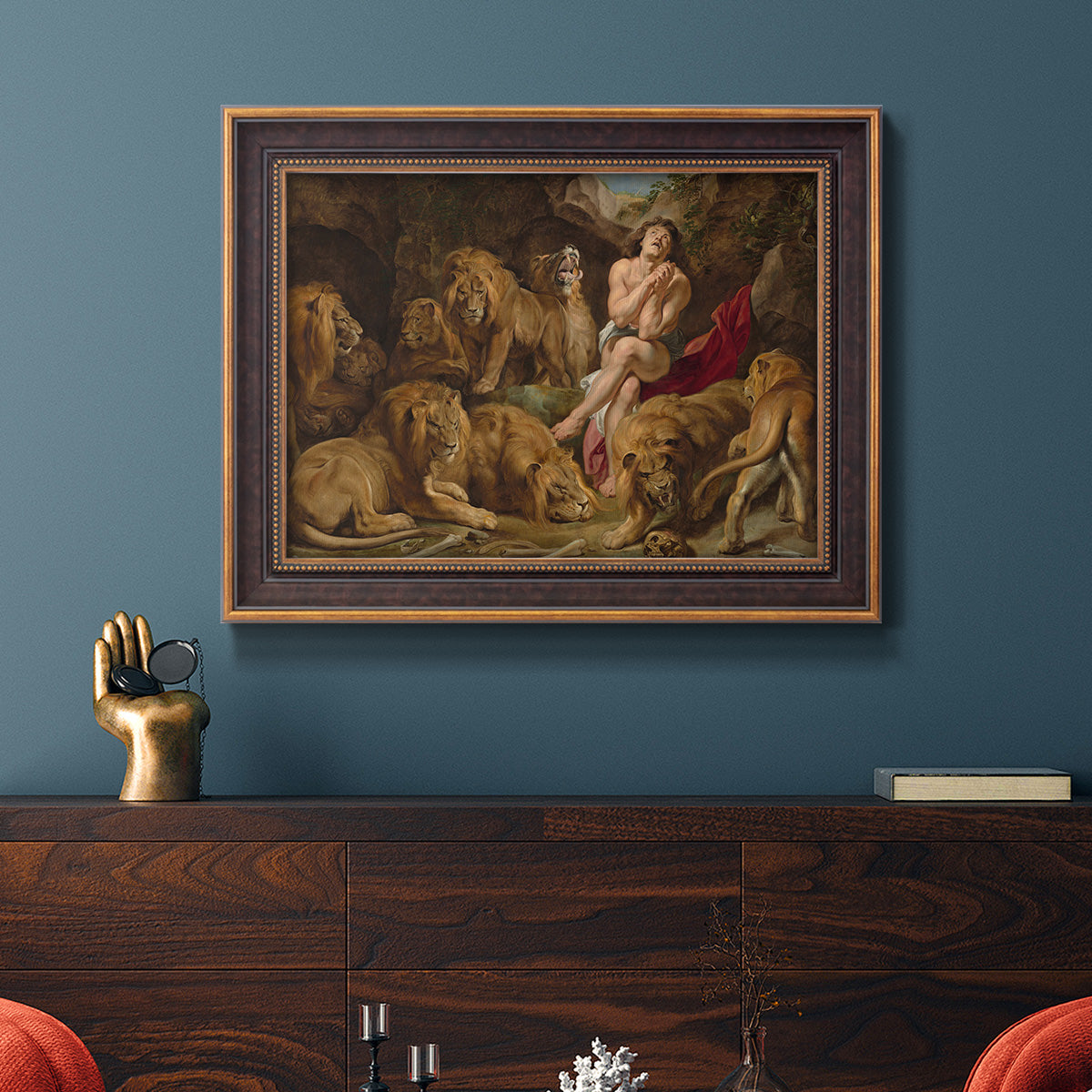 Dramatic biblical painting of Daniel with lions by Peter Paul Rubens in an ornate bronzed mahogany wood frame displayed in a dark-toned interior setting.
