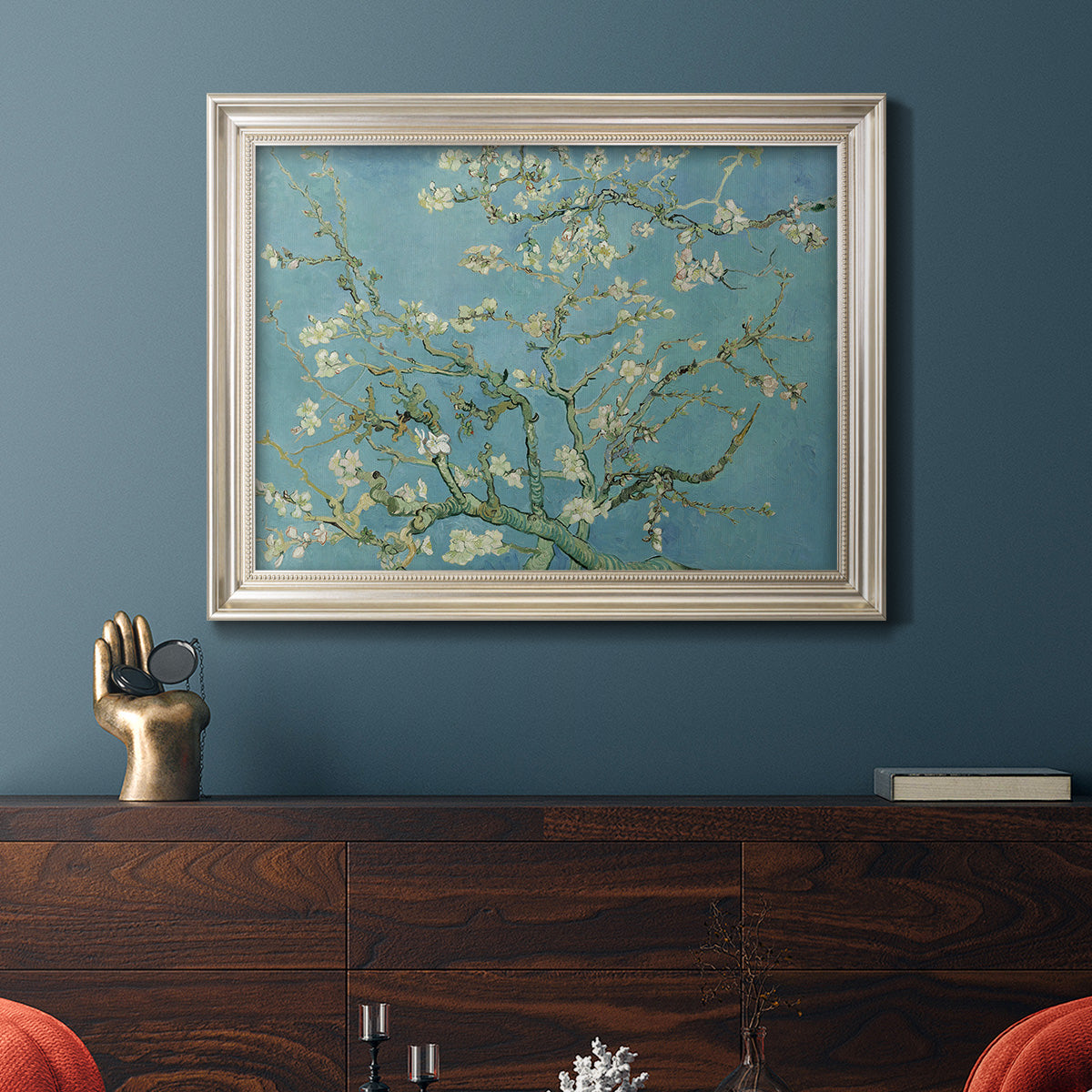Impressionist flowering almond branch painting by Vincent van Gogh in an ornate champagne frame displayed in a dark-toned interior setting.