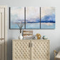 Three-panel canvas wall art featuring abstract bay with rhythmic forms, displayed above a cabinet in an entryway.