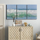 Three-panel canvas wall art featuring coastal waves breaking ashore, displayed above a cabinet in an entryway.