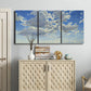 Three-panel canvas wall art featuring whimsical cloud filled sky landscape, displayed above a cabinet in an entryway.