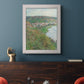 Impressionist landscape view of Vétheuil by Claude Monet in an ornate weathered white frame displayed in a dark-toned interior setting.