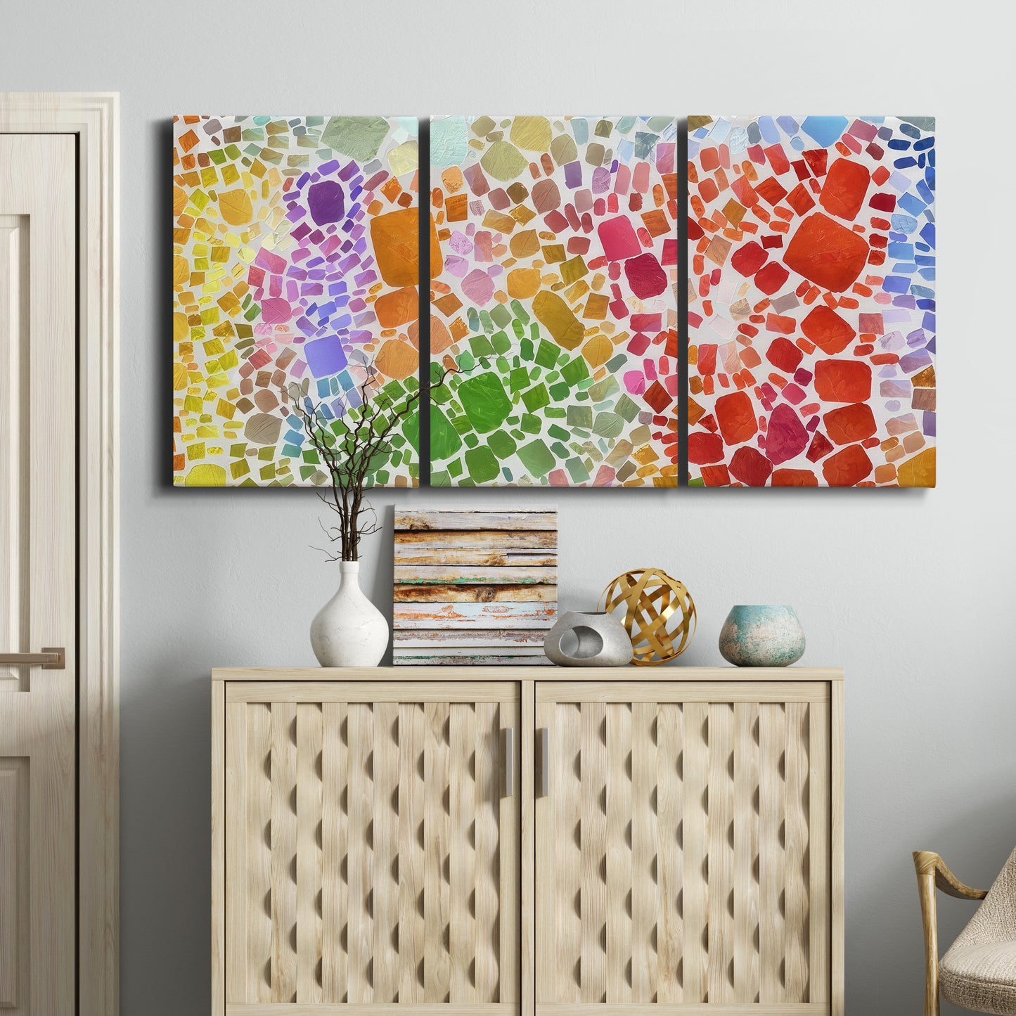 Three-panel canvas wall art featuring peaceful tropical inspired landscape, displayed above a cabinet in an entryway.