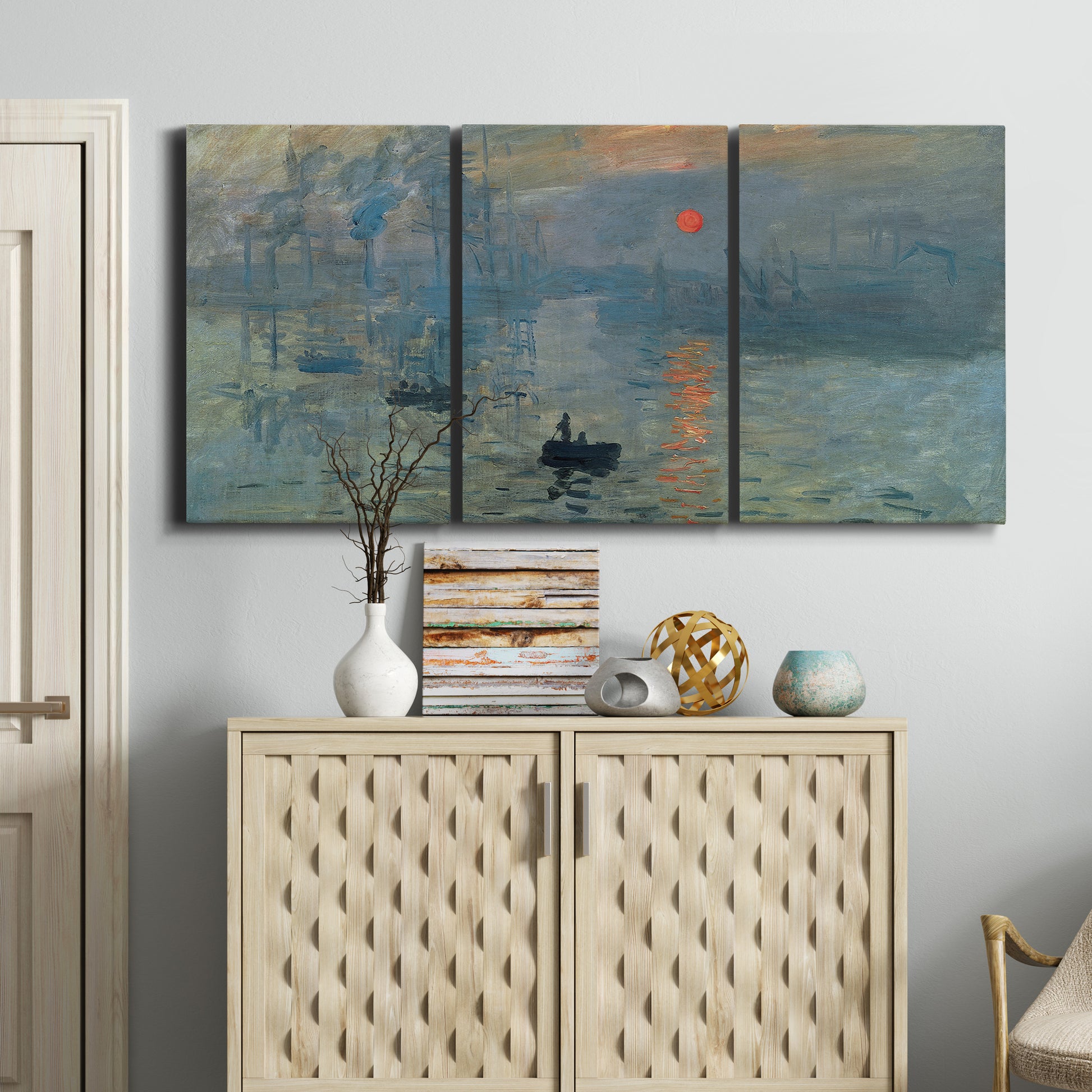 Three-panel canvas wall art featuring misty harbor sunrise with boats, displayed above a cabinet in an entryway.