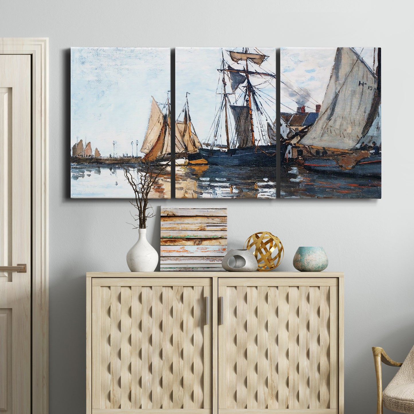 Three-panel canvas wall art featuring fishing boats navigating open water, displayed above a cabinet in an entryway.
