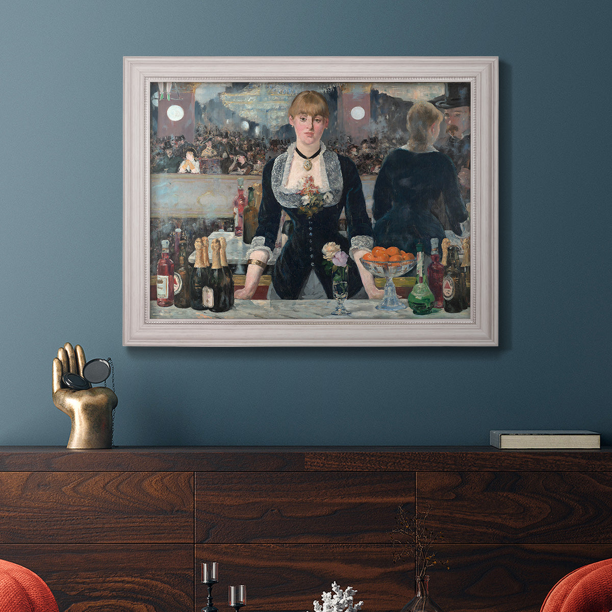 Iconic impressionist café bar scene by Édouard Manet in an ornate weathered white frame displayed in a dark-toned interior setting.