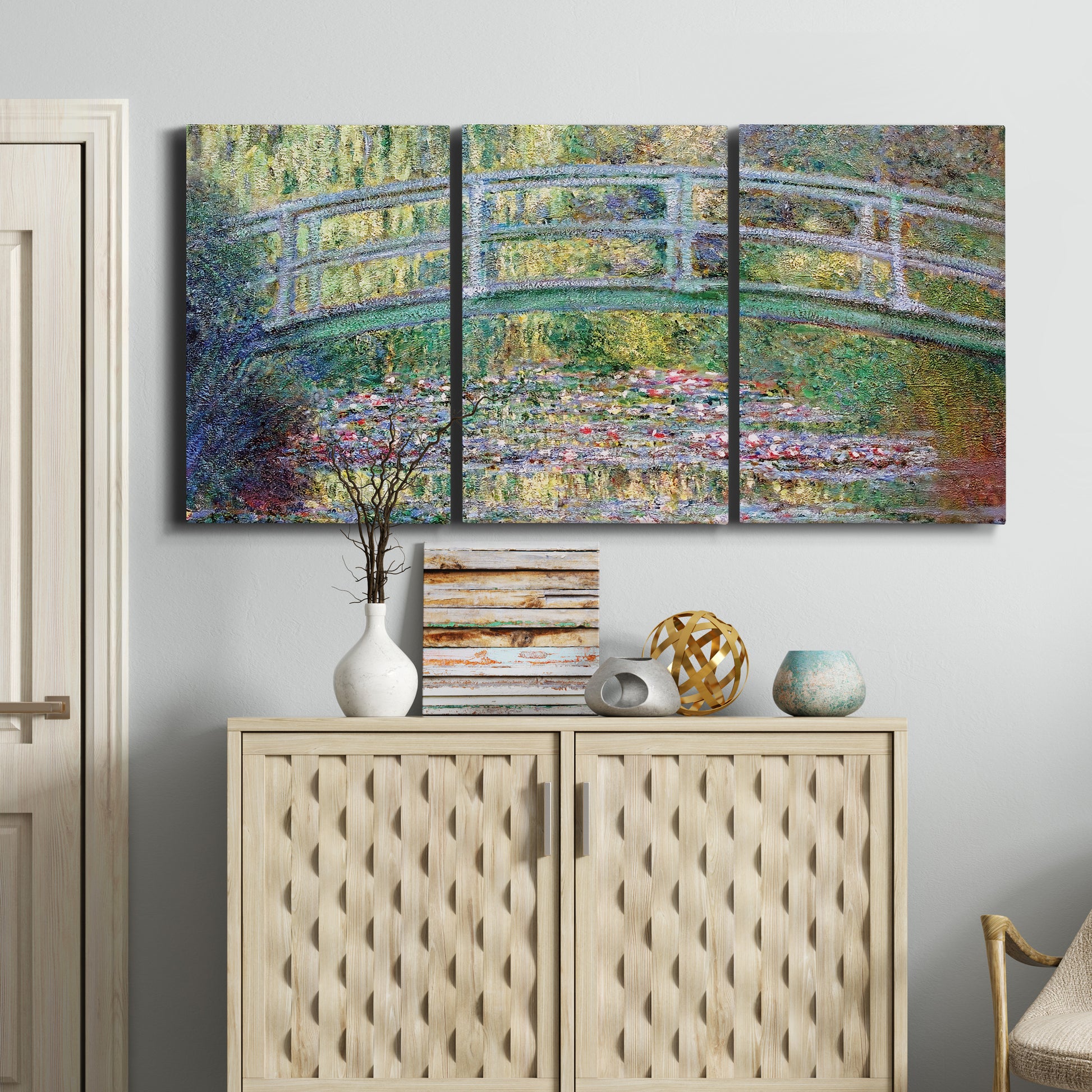 Three-panel canvas wall art featuring water lilies with arched bridge, displayed above a cabinet in an entryway.
