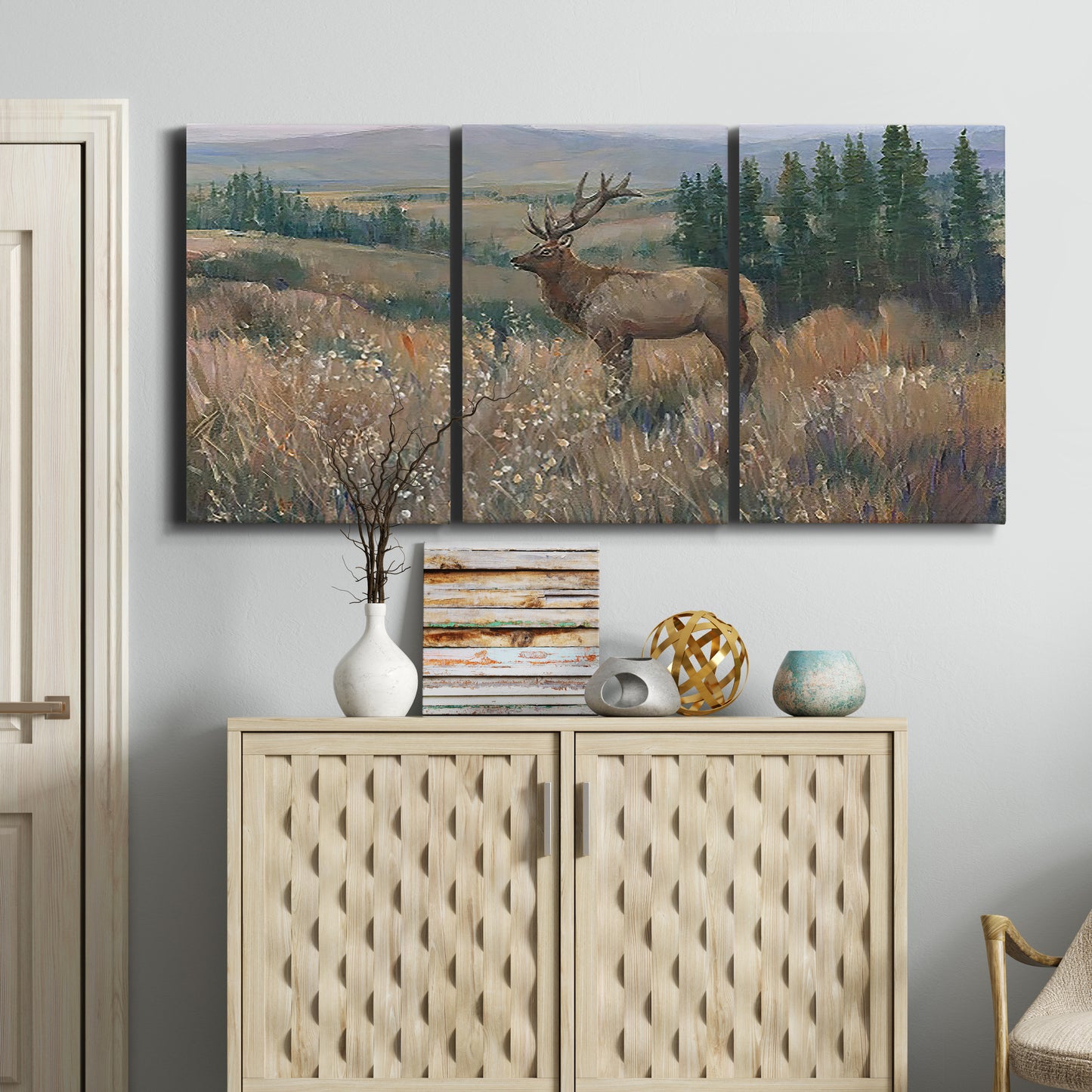 Three-panel canvas wall art featuring western wildlife standing in grassland, displayed above a cabinet in an entryway.
