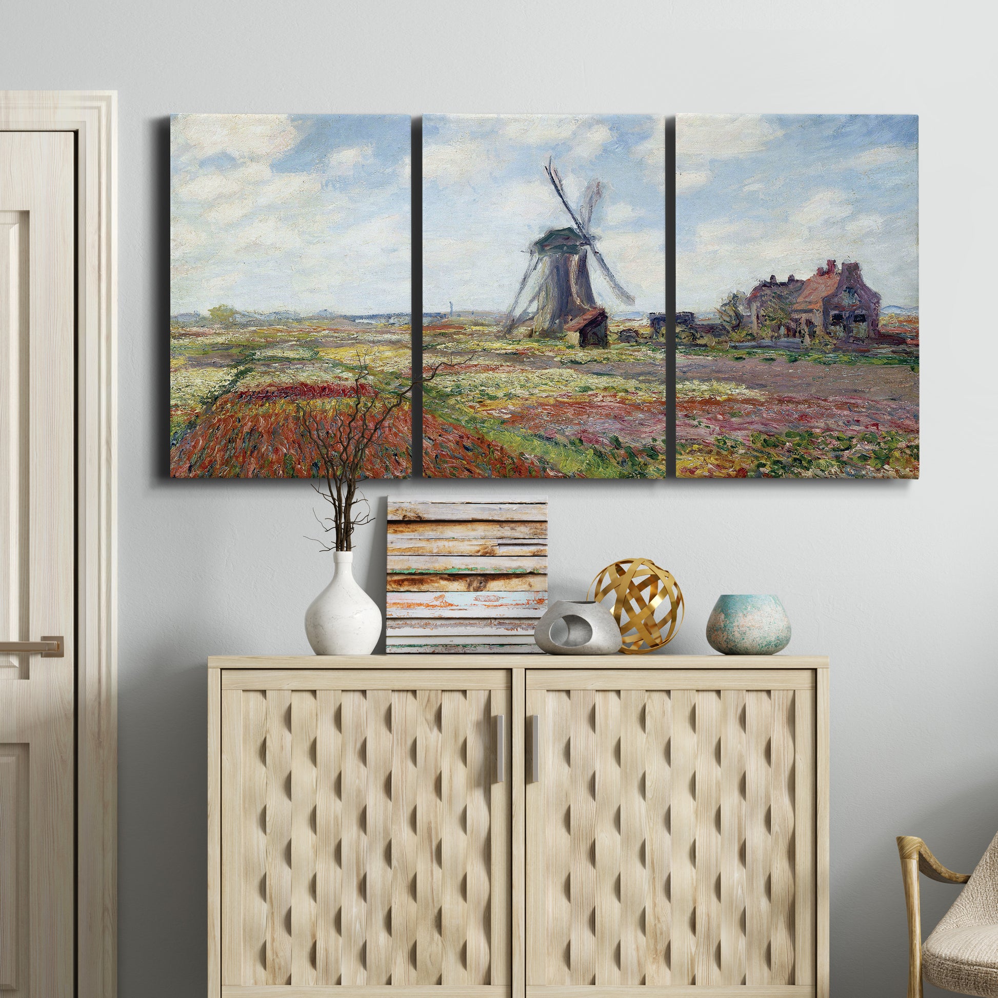 Three-panel canvas wall art featuring tulip fields with windmill, displayed above a cabinet in an entryway.