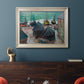 Impressionist coastal beach scene with boats by Claude Monet in an ornate champagne frame displayed in a dark-toned interior setting.