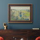 Impressionist rural hay harvest landscape by Camille Pissarro in an ornate bronzed mahogany wood frame displayed in a dark-toned interior setting.