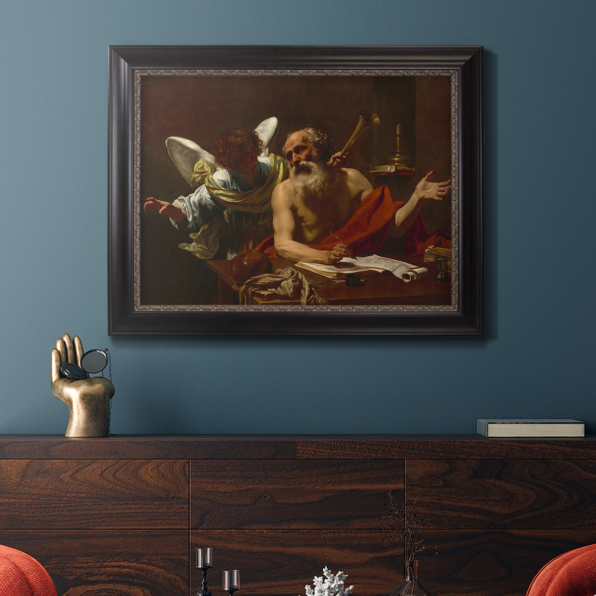 Classical religious painting of Saint Jerome with an angel by Simon Vouet in an ornate black frame with gilded inner detail displayed in a dark-toned interior setting.