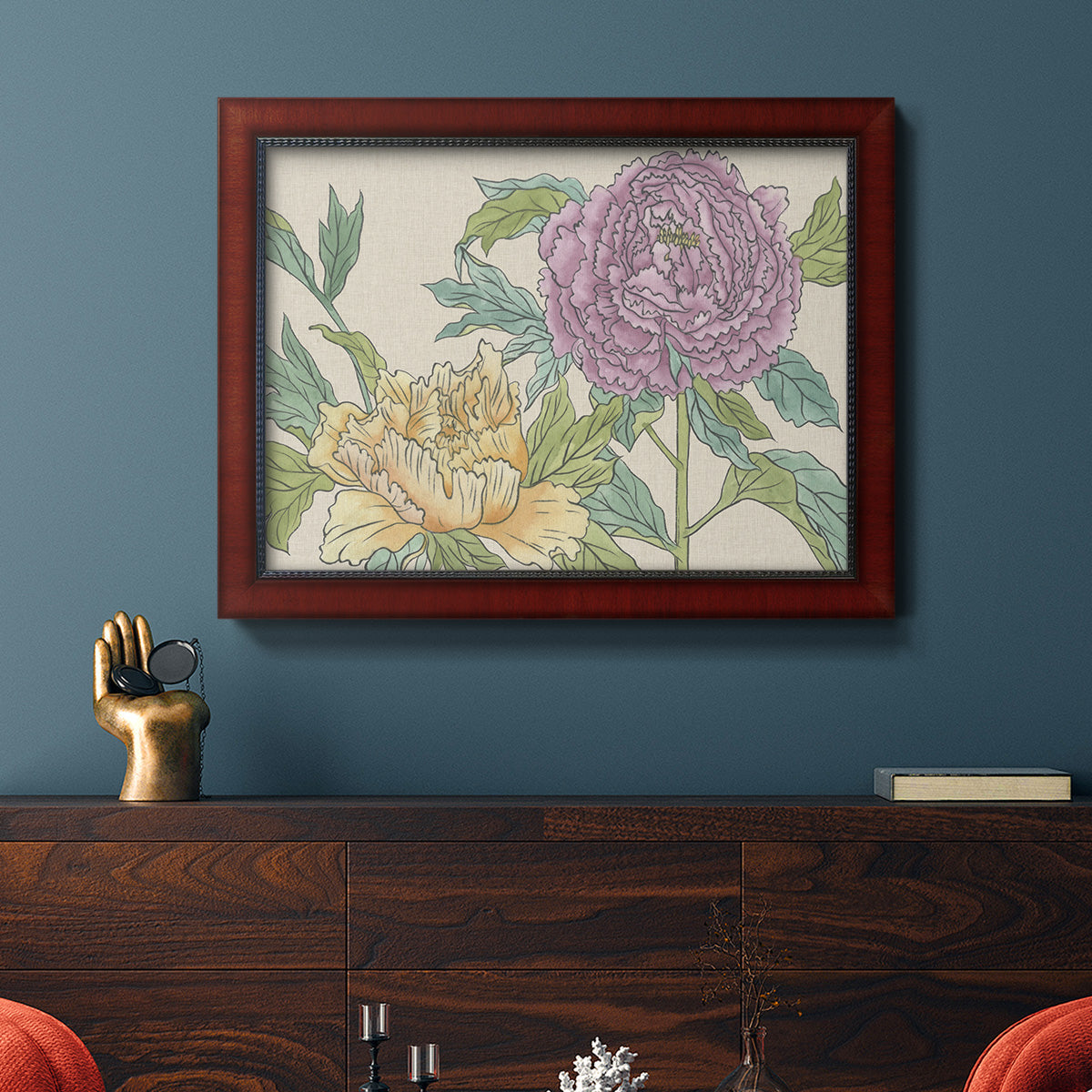 Contemporary peony flower illustration in an ornate cherry burl wood frame displayed in a dark-toned interior setting.