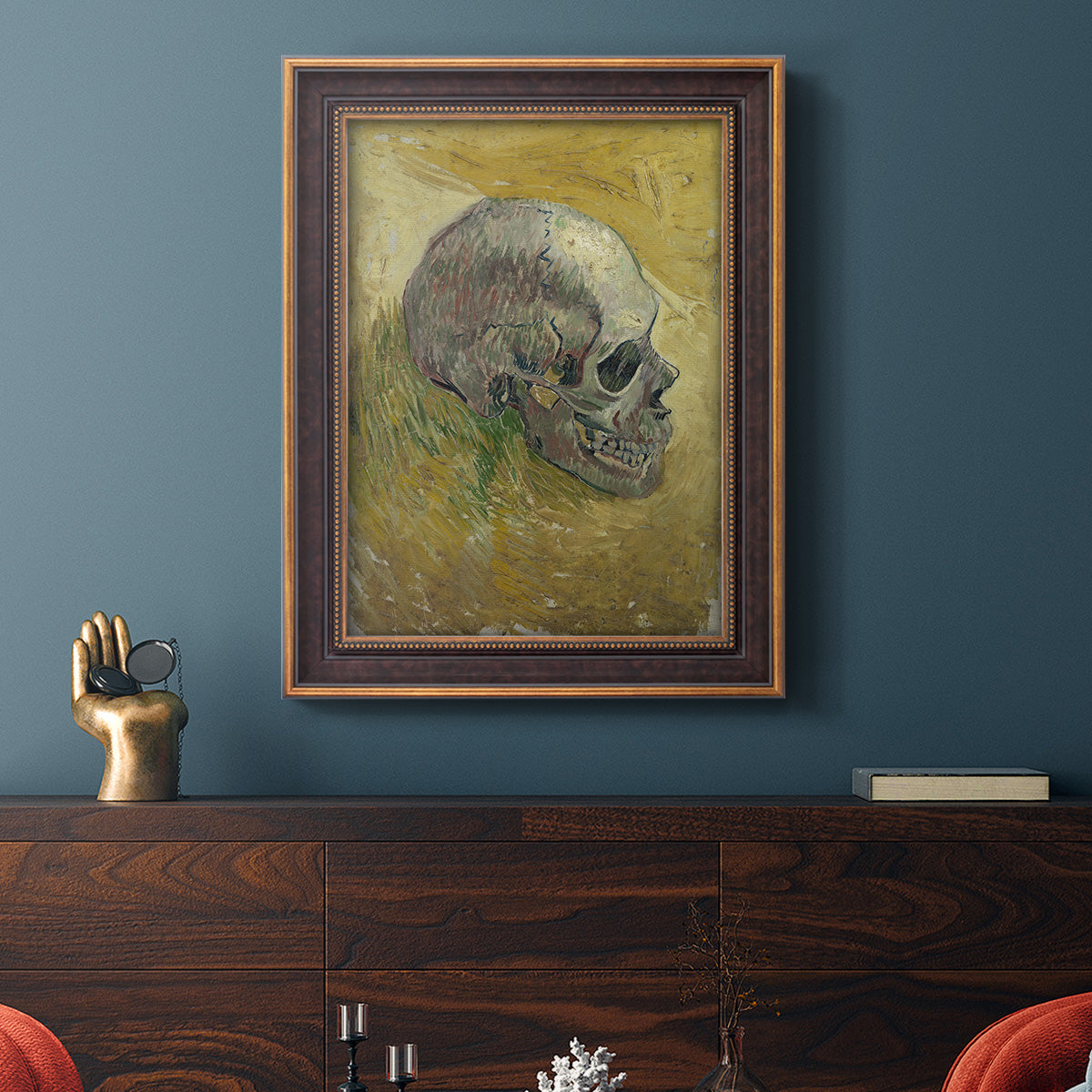 Profile skull study artwork by Vincent van Gogh in an ornate bronzed mahogany wood frame displayed in a dark-toned interior setting.