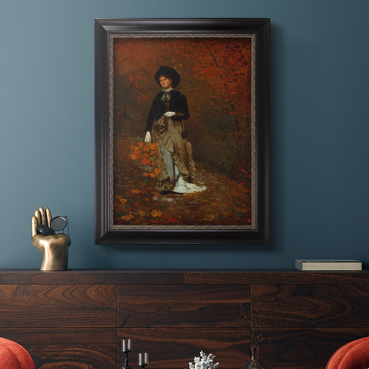 Realist autumn portrait scene by Winslow Homer in an ornate black frame with gilded inner detail displayed in a dark-toned interior setting.