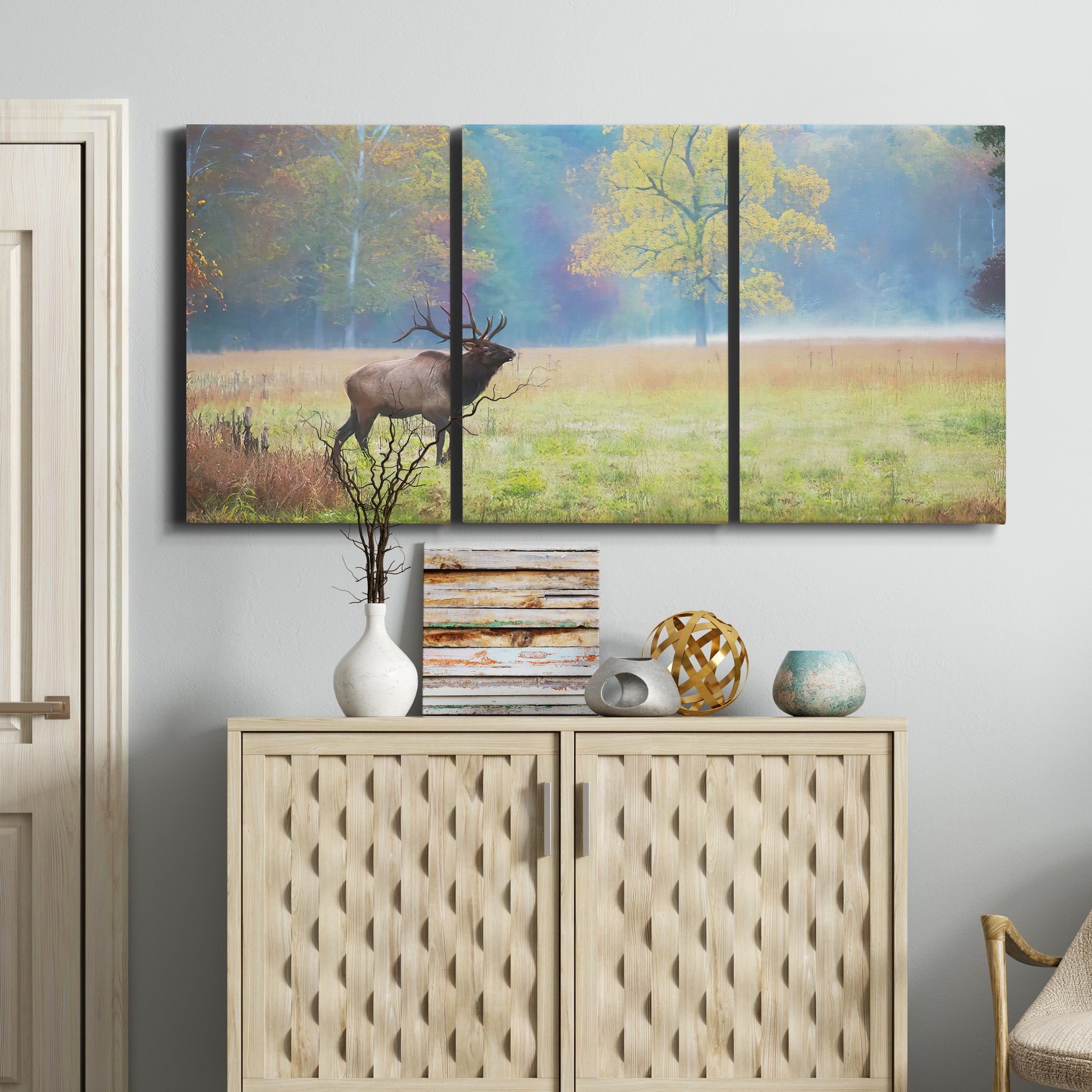 Three-panel canvas wall art featuring resting animals in open field, displayed above a cabinet in an entryway.