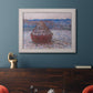 Impressionist single haystack landscape by Claude Monet in an ornate weathered white frame displayed in a dark-toned interior setting.