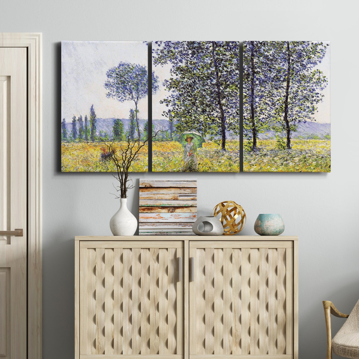 Three-panel canvas wall art featuring sunlight filtering through tall poplars, displayed above a cabinet in an entryway.
