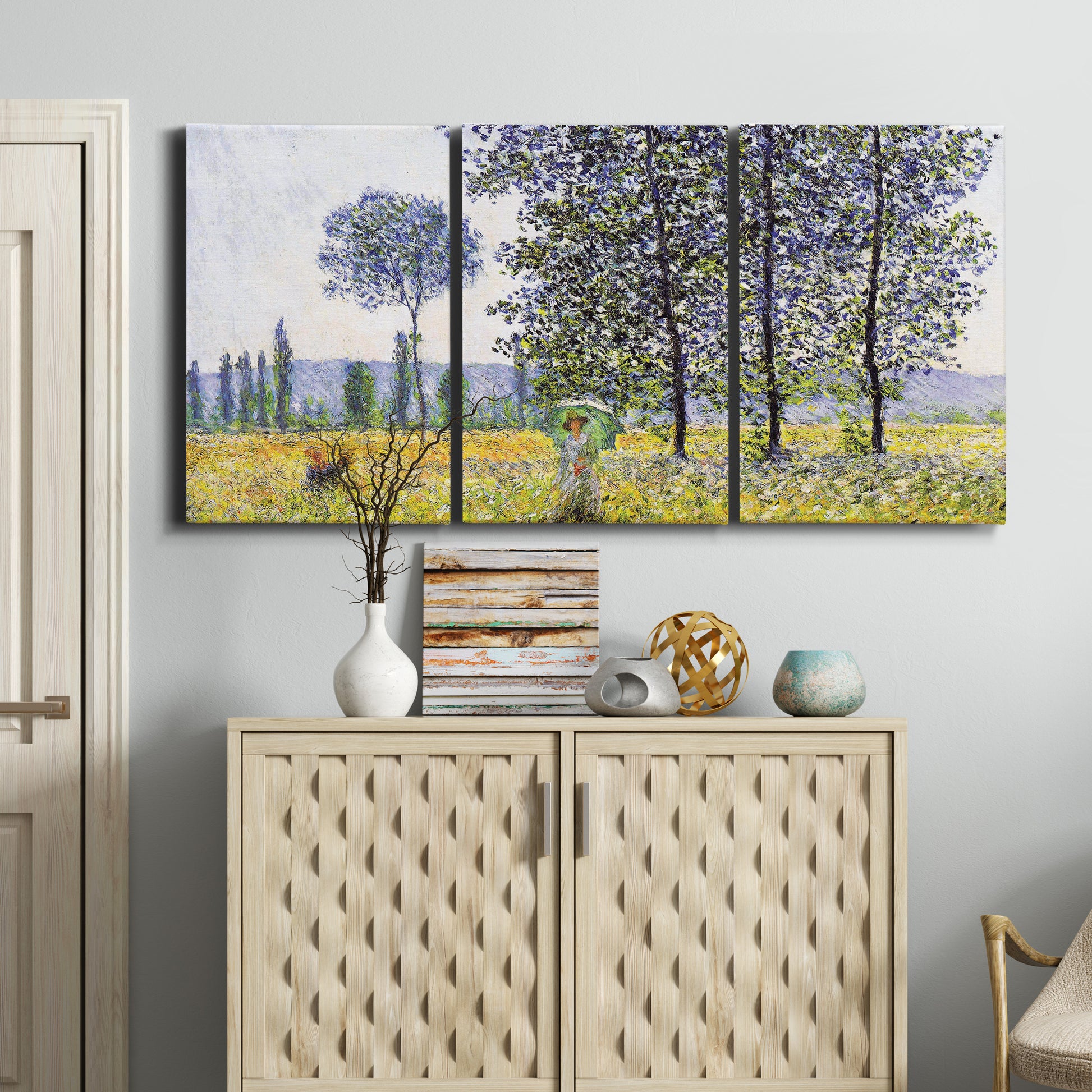 Three-panel canvas wall art featuring sunlight filtering through tall poplars, displayed above a cabinet in an entryway.