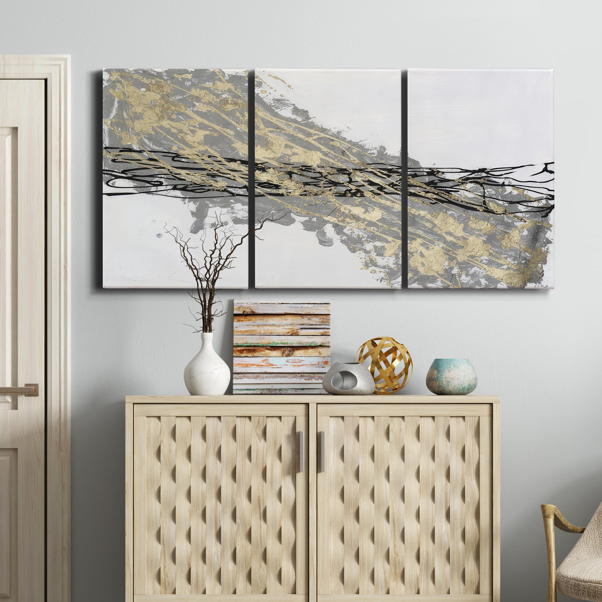 Three-panel canvas wall art featuring light modern abstract wind patterns, displayed above a cabinet in an entryway.