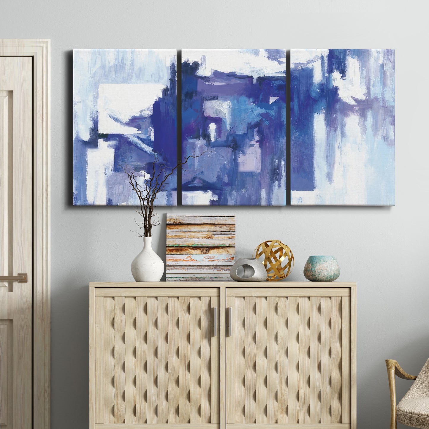 Three-panel canvas wall art featuring abstract urban street scene, displayed above a cabinet in an entryway.