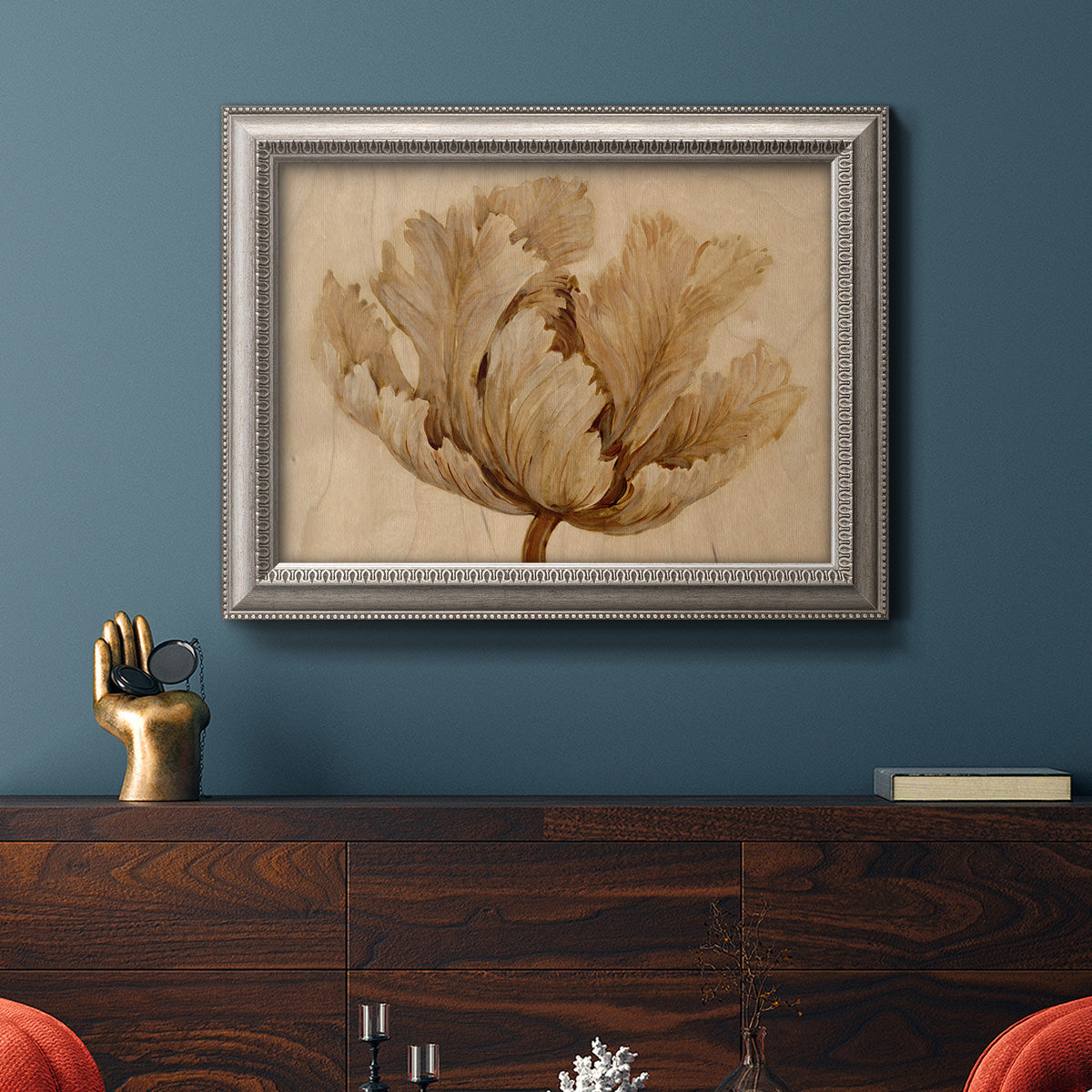 Minimalist sepia tulip botanical artwork in an ornate vintage silver frame displayed in a dark-toned interior setting.